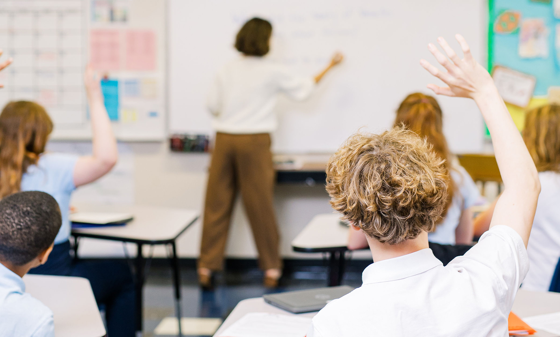 Student asking question in classroom at Canterbury