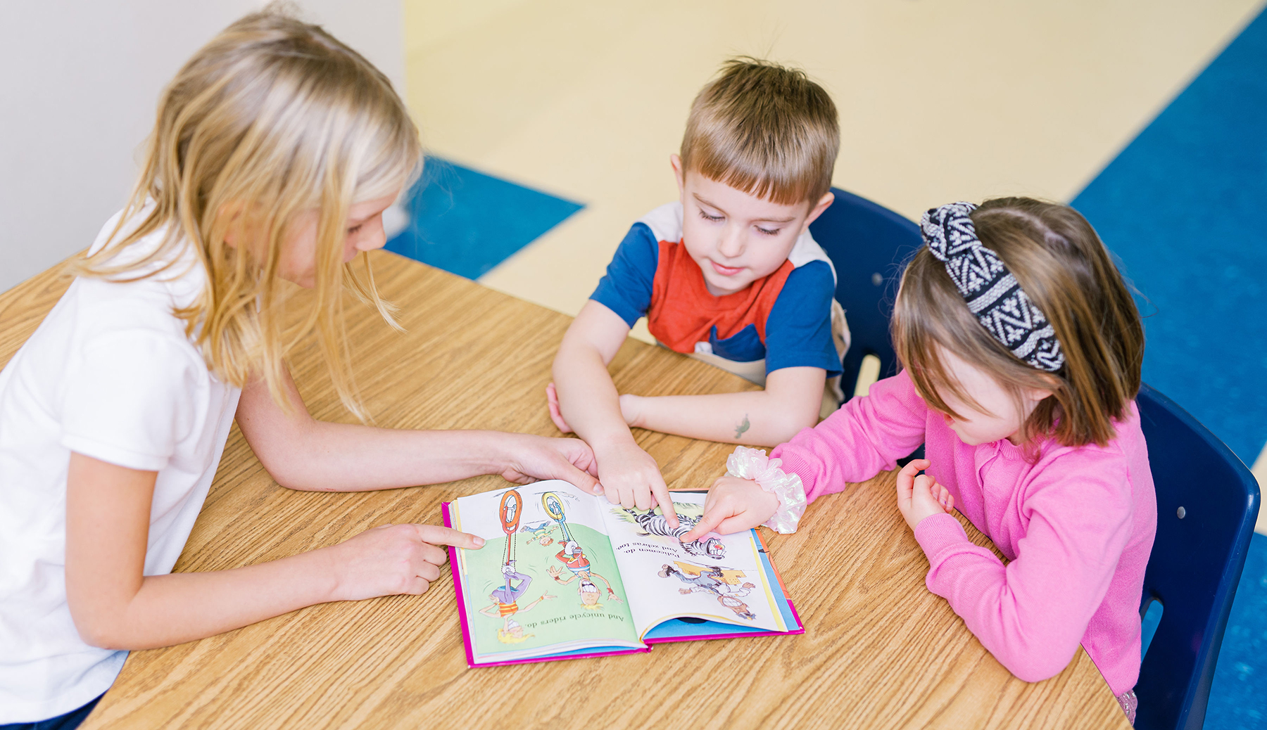 Young Canterbury students reading at a table